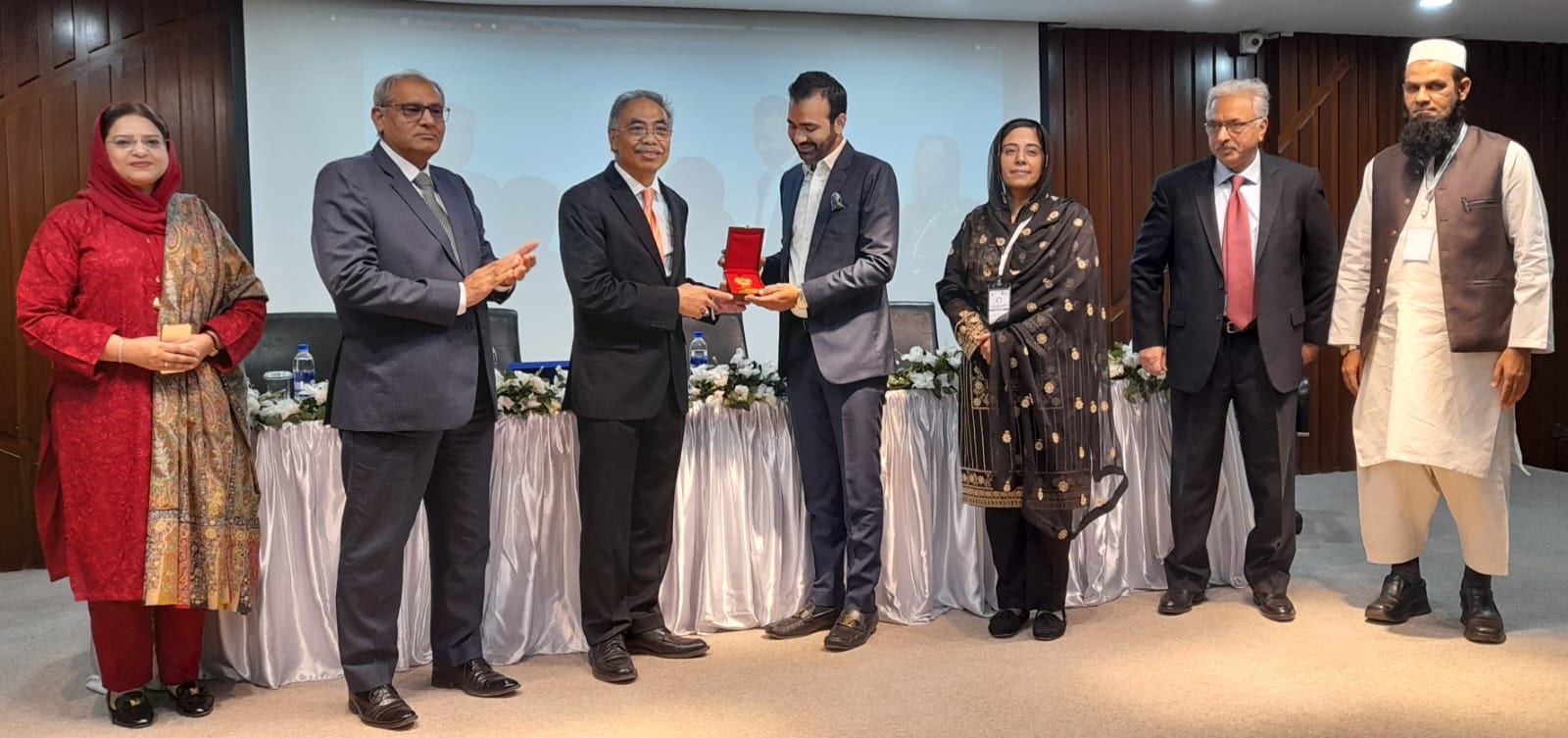 Indonesian Ambassador-designated Pakistan presenting gift/award.