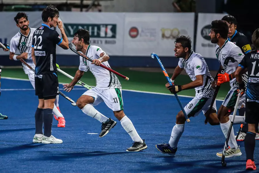 Pakistan National Hockey Players celebrating after scoring a goal against Japan.