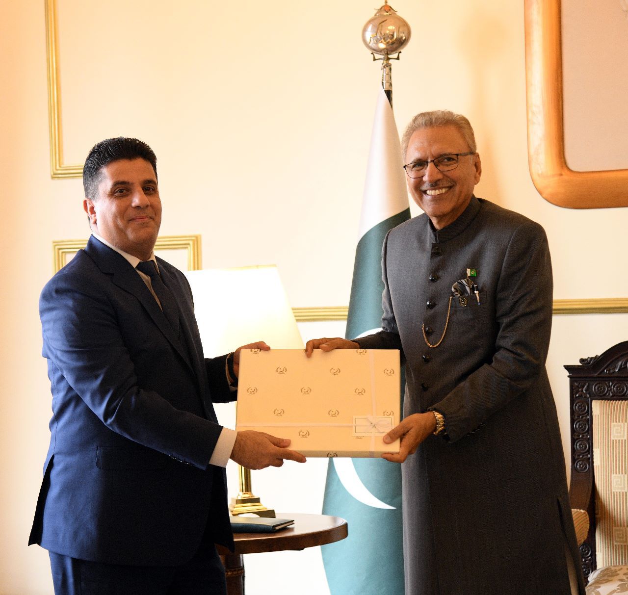 The President of Pakistan, Arif Alvi, receiving the credentials from Ambassador of Syria, Ramez Alraee.