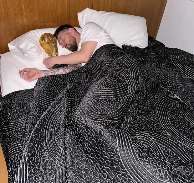 Messi posted his picture of sleeping while holding the FIFA World cup trophy.