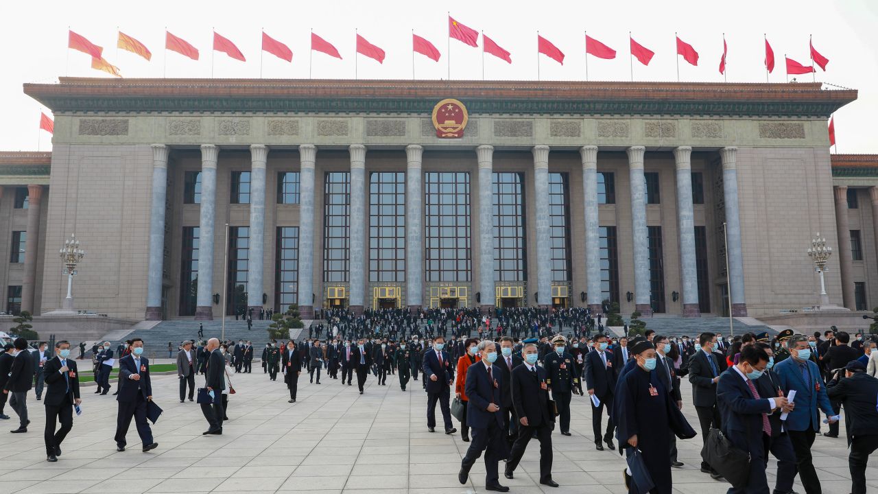 people are seen passing through the Great Hall of the People as the Two Sessions, an annual gathering, begin in Beijing