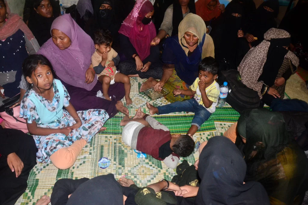 On March 27, 2023, Rohingya women and children arrive in Kaula Matang Peulawi, Aceh Province, Indonesia, and take a rest inside a mosque that has been converted into a temporary shelter.
