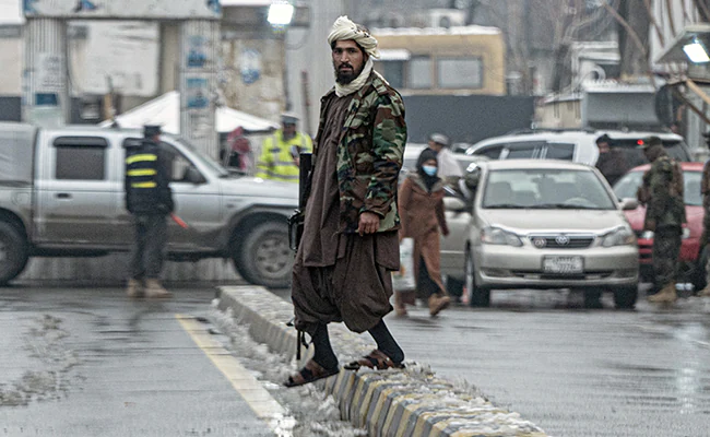 A Taliban soldier stands guard in Kabul close to the Afghan foreign ministry

