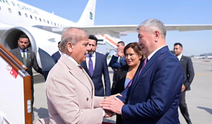 Pakistani Prime Minister Shehbaz Sharif shakes hands with Adylbek Kasymaliev on the airport tarmac