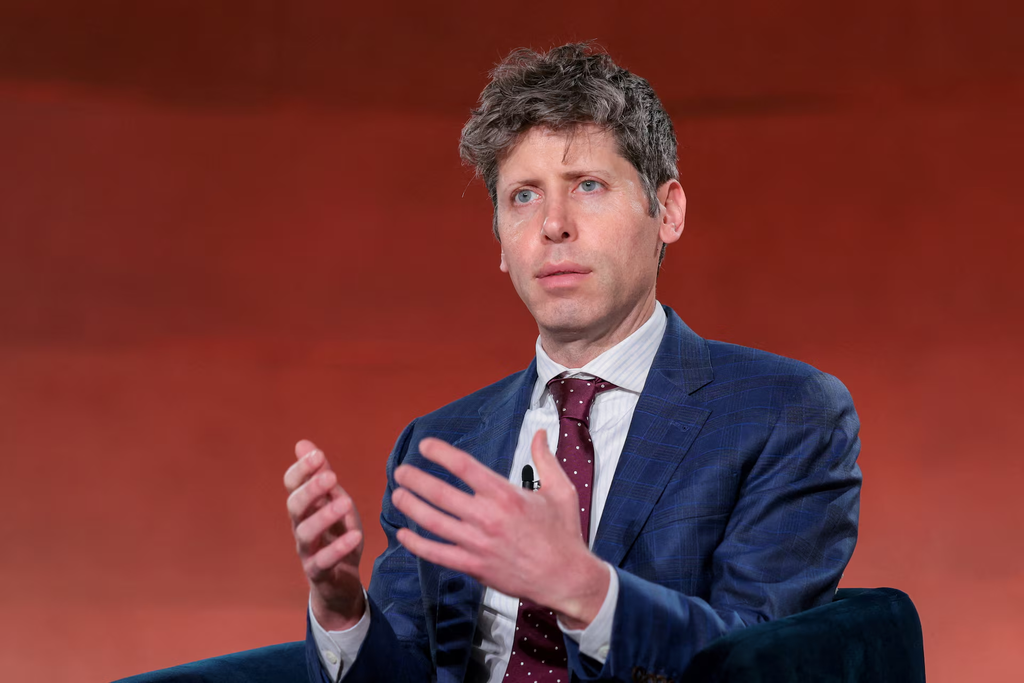 Sam Altman gestures with his hands while speaking onstage