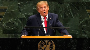 Donald Trump speaking at a podium bearing the United Nations emblem