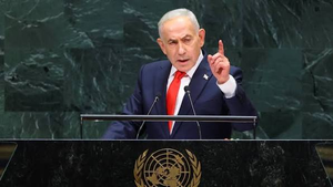 Benjamin Netanyahu gestures with a raised finger while speaking at the United Nations General Assembly podium