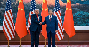 Donald Trump and China's President Xi Jinping shake hands in front of alternating U.S. and Chinese flags