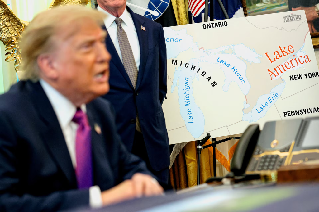 Donald Trump speaking in front of a Great Lakes map where Lake Ontario is labeled Lake America