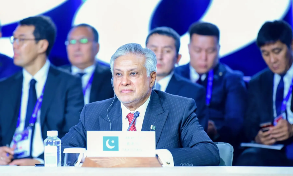 Ishaq Dar seated behind a Pakistan delegation placard at an international conference