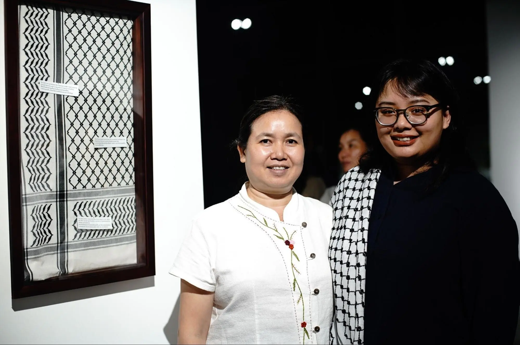 Mae (left) and Souvixada (right) at an exhibition showcasing a hand-woven silk keffiyeh in Vientiane.