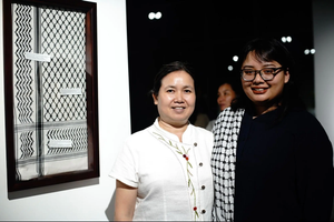 Mae (left) and Souvixada (right) at an exhibition showcasing a hand-woven silk keffiyeh in Vientiane.